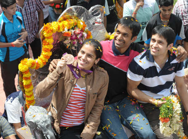 Champion Saina returns home 