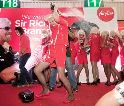 Richard Branson dresses up as AirAsia flight attendant