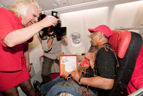 Richard Branson dresses up as AirAsia flight attendant