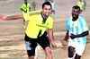Dhoni plays football with villagers