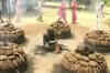 Holy man braves piles of burning cow-dung as ritual
